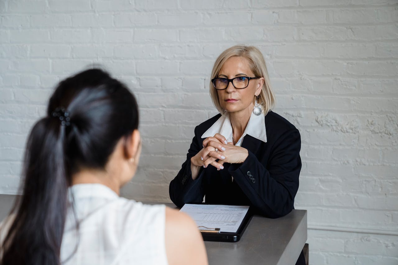 Crafting Captivating Headlines: Your awesome post title goes here Professional businesswoman in a black blazer conducting an interview indoors.