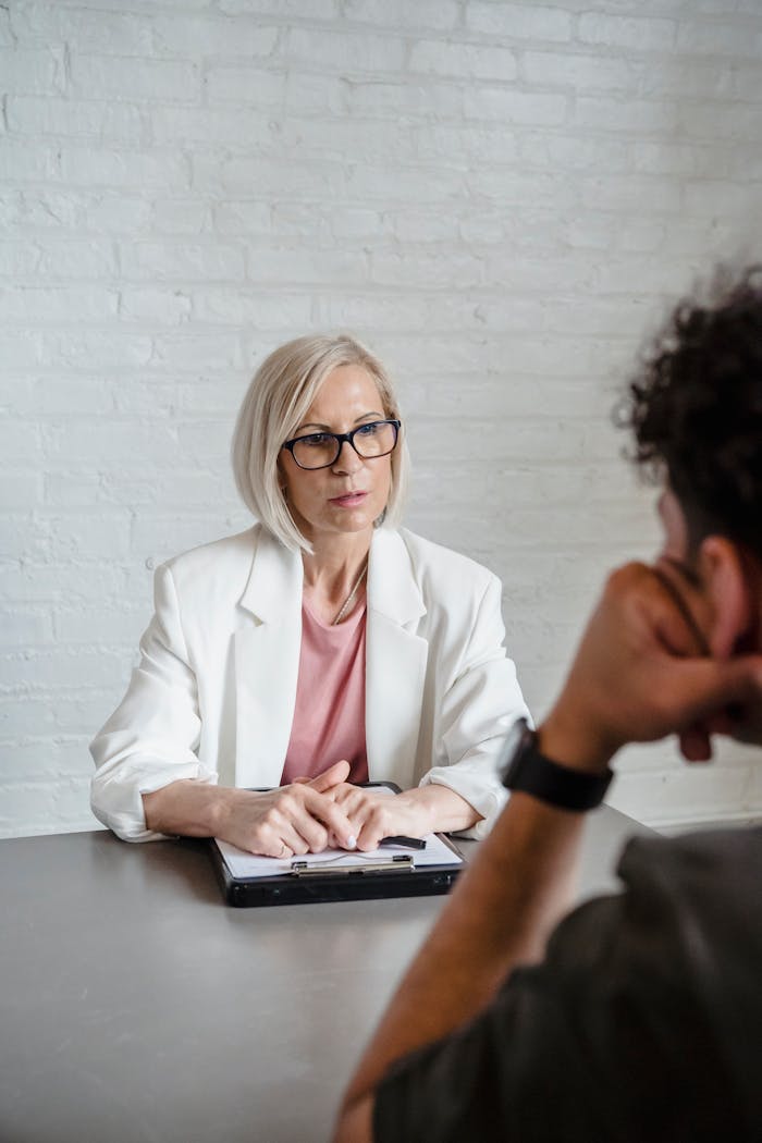 services-03 A serious business discussion between a consultant and a client in an office setting.